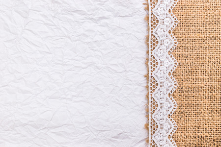Close up of Lace flowers frame and Burlap over paper texture design for border or backgroundの写真素材
