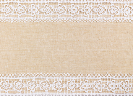 Lace flowers frame on Fabric texture backgroundの写真素材