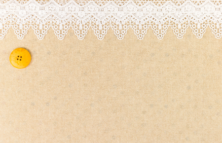 Lace border over fabric with sewing button over Fabric texture design for backgroundの写真素材