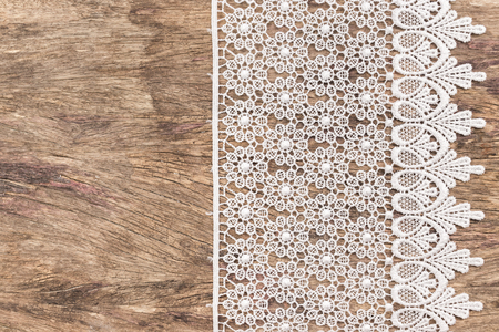 Close up of Lace flowers frame over wooden texture design for border or backgroundの写真素材