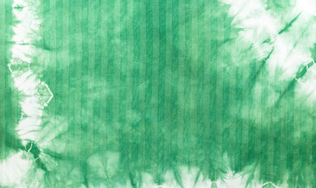 Green tie dye batik fabric for background and textureの写真素材
