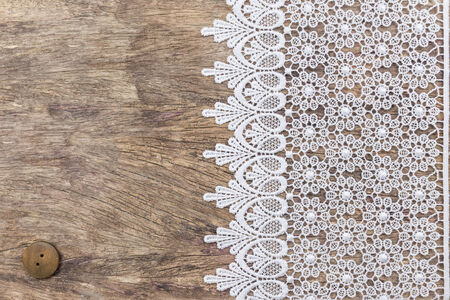 White Ornamental Lace over wooden texture design for border or backgroundの写真素材