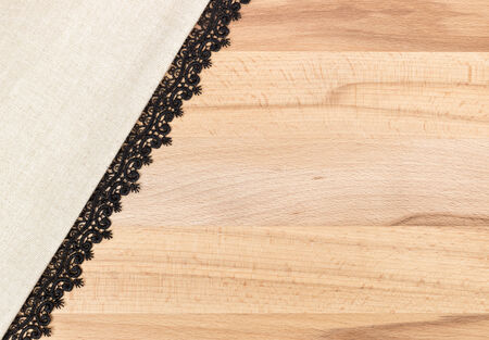 White Fabric with black Lace over wooden table texture design for backgroundの写真素材