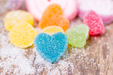 Close up of colorful fruit jelly candies over wooden backgroundの写真素材