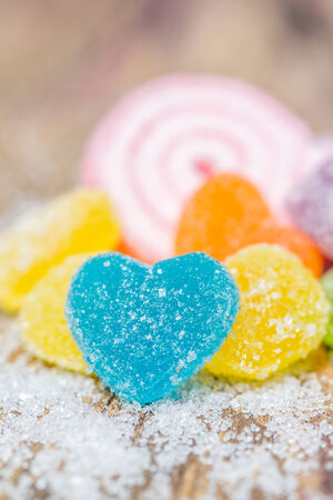Close up of colorful fruit jelly candies over wooden backgroundの写真素材