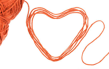yarn thread wit heart sign isolated on white backgroundの写真素材