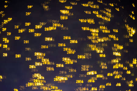 Out of focus gold Christmas lights in 2016 word abstract. backgroundの写真素材