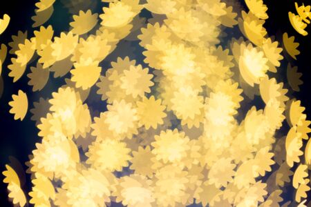 Out of focus gold Christmas lights in flower shaped abstract. backgroundの写真素材