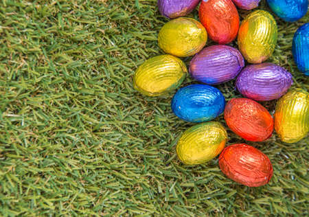 Chocolate Easter Eggs  over green grass background