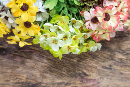 Artificial flowers over wooden backgroundの写真素材