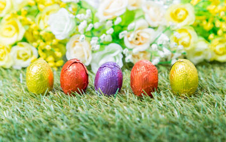 Row of colorful Easter eggs in green grass