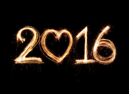 2016 word written with Sparkle firework on black backgroundの写真素材