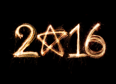 2016 word written with Sparkle firework on black backgroundの写真素材