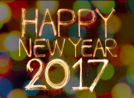 Happy new year 2017 word made from sparkler light firework on bokeh backgroundの写真素材