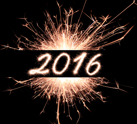 2016 written with Sparkle firework over black background