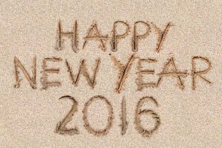 Happy New Years 2016 on the sand backgroung Texture