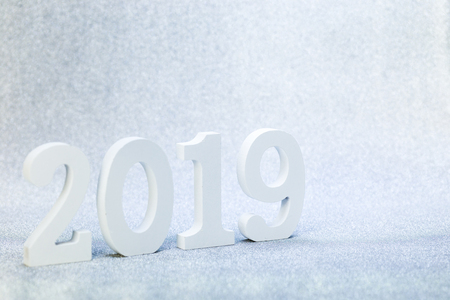 2019 year white wood character in perspective over sparkling wall background textureの写真素材