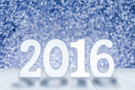 2016 year white wood number in perspective room with sparkling bokeh wall and white wooden plank floorの写真素材