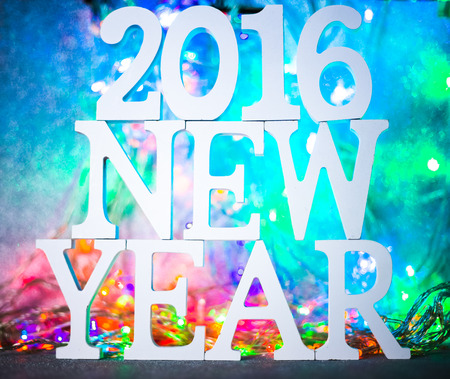 2016 New year white wood character over Defocused bokeh christmas light backgroundの写真素材