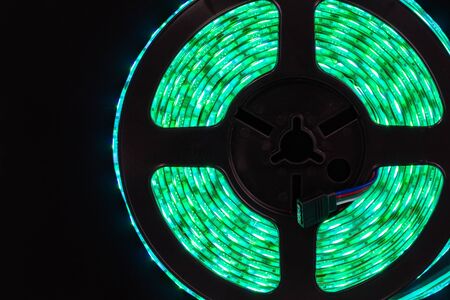 Led stripe light in coil on black background