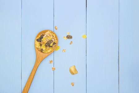 Healthy Granola Whole grains with nuts and dried berries in wooden spoon