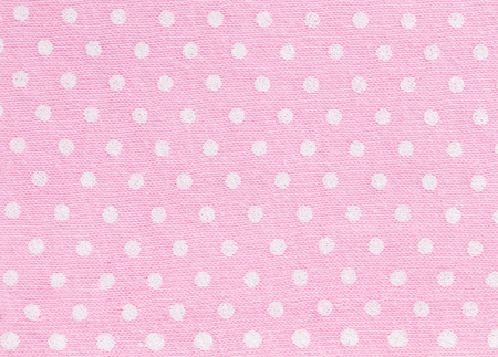 White Polka dot over Pink  fabric background and textureの写真素材