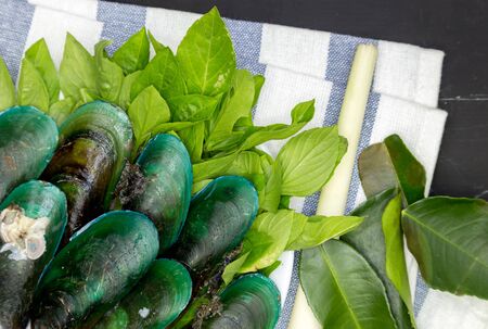 Green-lipped mussels with Basil on wooden tableの写真素材