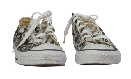 A pair of camouflage sneakers against white backgroundの写真素材
