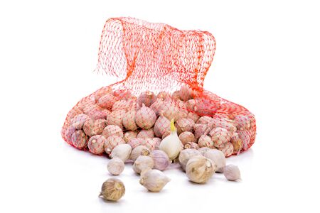 Clove garlic in a plastic bags isolate on white backgroundの写真素材