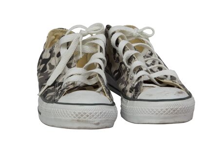 A pair of camouflage sneakers against white backgroundの写真素材