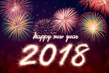 Happy new year 2018 written with Sparkle firework with firework backgroundの写真素材