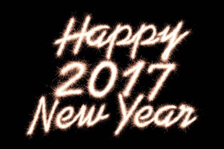 Happy new year 2017 written with Sparkle firework on black backgroundの写真素材