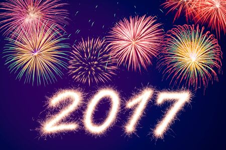 Happy new year 2017 written with Sparkle firecracker and fireworkの写真素材