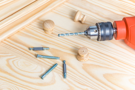 Diy Furniture assembly with electric drill and screw on wooden boardの写真素材