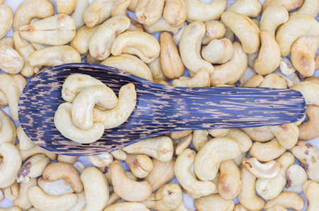 cashew nuts in wooden spoon on cashew nuts backgroundの写真素材