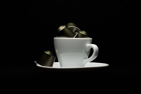 Cup of coffee with capsules on black backgroundのeditorial素材