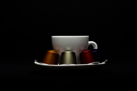 Cup of coffee with capsules on black backgroundのeditorial素材