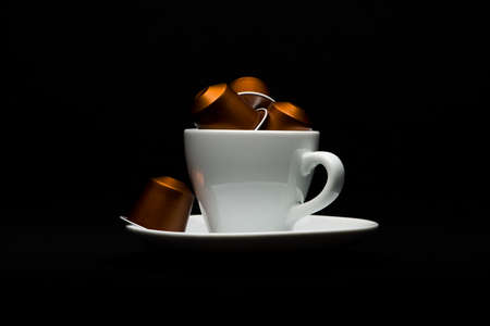 Cup of coffee with capsules on black backgroundのeditorial素材