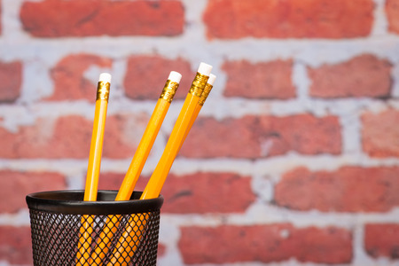 Pencil for school in front of brick wallの写真素材