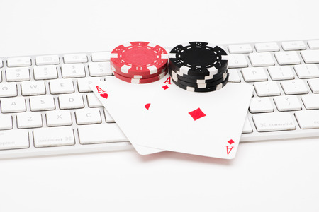 Poker cards on web keyboard on white backgroundの写真素材