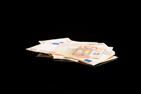 Poker money on black background with reflexionの写真素材