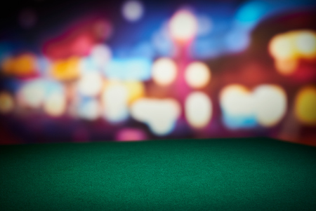 Poker green table in casino with blur background