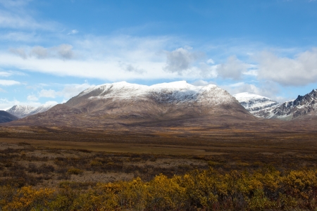 Wilderness of Alaska tundra in late fall with snow on mountainsの写真素材