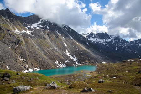 Alpine lake at base of rugged mountainの写真素材