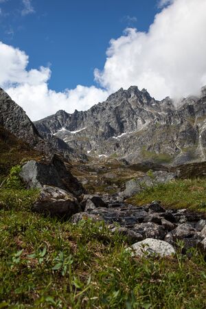 A small stream runs through mountainsの写真素材