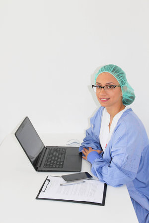 A young woman doctor With a laptop in her officeの写真素材