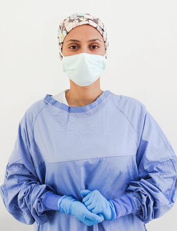 Portrait of a surgeon with gloves and a face maskの写真素材