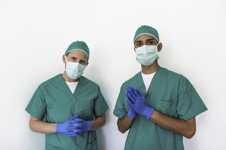 Two man nurses with gloves and a maskの写真素材