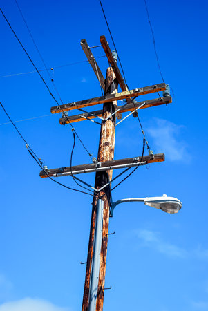 electricity post with blue sky in the background, note shallow depth of fieldの写真素材