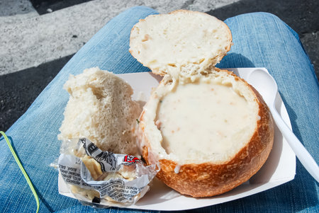 Bread and cheese soup in a plastic container on the street.の写真素材